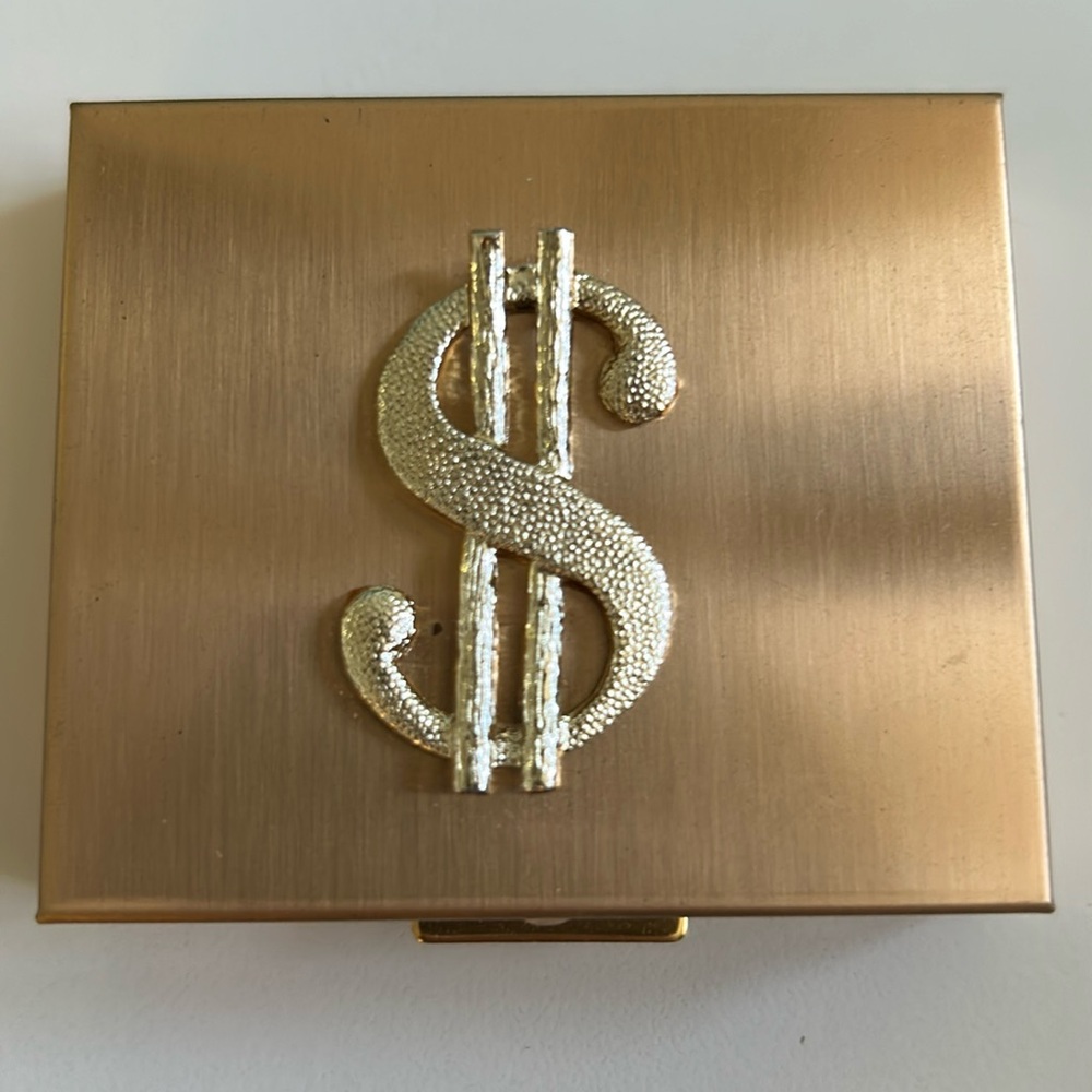 Vintage gold tone metal money case for coins and bills.